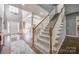 Welcoming staircase with carpeted steps and light wood railing leading to the upper level of the home at 11006 Knight Castle Dr, Charlotte, NC 28277