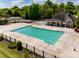 Aerial view showcases a community pool with ample lounging space, a pavilion, and mature landscaping at 11006 Knight Castle Dr, Charlotte, NC 28277