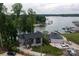 Aerial view of a lakefront home featuring well-maintained landscaping and private beach at 113 Angler Pl, Mooresville, NC 28117