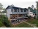 Backyard with deck, seating area and fire pit, landscaped with gravel and grass at 113 Angler Pl, Mooresville, NC 28117