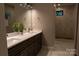 Bright bathroom featuring a double sink vanity and a marble tiled shower with a window at 113 Angler Pl, Mooresville, NC 28117