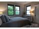 Comfortable bedroom with three windows showcasing the outdoor view at 113 Angler Pl, Mooresville, NC 28117
