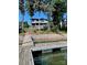 Home featuring a dock on the water and a grassy backyard at 113 Angler Pl, Mooresville, NC 28117