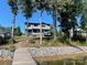 View of the home from the lake, showing the multi-level deck and backyard at 113 Angler Pl, Mooresville, NC 28117