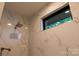 Beautifully tiled shower stall featuring marble tile and a window at 113 Angler Pl, Mooresville, NC 28117