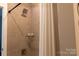 Shower featuring sleek fixtures, tiled walls and a glass toiletry shelf at 113 Angler Pl, Mooresville, NC 28117