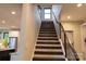View of the staircase with dark wood steps and a black metal railing, illuminated by a window at the landing at 113 Angler Pl, Mooresville, NC 28117