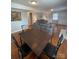 Dining area with a dark brown table and black chairs at 1615 Bonnie Ln, Charlotte, NC 28213