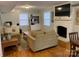 Living room with hardwood floors, fireplace, and comfy sofas at 1615 Bonnie Ln, Charlotte, NC 28213