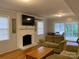 Living room with hardwood floors, fireplace, and a view of the patio at 1615 Bonnie Ln, Charlotte, NC 28213