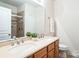 Clean bathroom with double vanity, walk-in shower, and toilet at 2019 Stoney Point Cir, Monroe, NC 28112