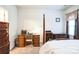 Well-lit bedroom with a desk and chair, dresser, and comfortable bed at 2019 Stoney Point Cir, Monroe, NC 28112