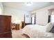 Bright bedroom with a comfortable bed, wooden desk and chair, and dresser at 2019 Stoney Point Cir, Monroe, NC 28112