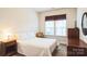 Charming bedroom with a comfortable bed, nightstand, and window at 2019 Stoney Point Cir, Monroe, NC 28112