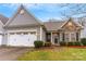 Gray siding home with stone accents, two-car garage, and landscaped yard at 2019 Stoney Point Cir, Monroe, NC 28112