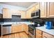 Kitchen with light wood cabinets, stainless steel appliances, and granite countertops at 2019 Stoney Point Cir, Monroe, NC 28112
