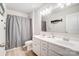 Clean bathroom with double vanity and a grey shower curtain at 3594 Cerelia Ln, Denver, NC 28037