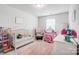 Charming Bedroom with a crib, rocker, and play areas at 3594 Cerelia Ln, Denver, NC 28037