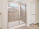 Walk-in shower with glass enclosure and neutral tile at 3594 Cerelia Ln, Denver, NC 28037