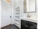 Bathroom with a pedestal sink, built-in shelving and hexagon tile floor at 414 W Harvie Ave, Gastonia, NC 28052