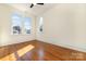 Sunny bedroom with hardwood floors and multiple windows at 414 W Harvie Ave, Gastonia, NC 28052