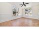 Well-lit bedroom with hardwood floors and wainscoting at 414 W Harvie Ave, Gastonia, NC 28052
