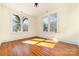 Bright bedroom with hardwood floors and large windows at 414 W Harvie Ave, Gastonia, NC 28052