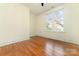 Spacious bedroom featuring hardwood floors and a window at 414 W Harvie Ave, Gastonia, NC 28052