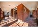 Brick front porch with tiled flooring and double entry doors at 414 W Harvie Ave, Gastonia, NC 28052
