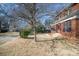 Brick house with a screened porch, steps, and a tree in the front yard at 414 W Harvie Ave, Gastonia, NC 28052
