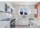 White kitchen with stainless steel appliances and view at 414 W Harvie Ave, Gastonia, NC 28052
