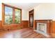 Living room with hardwood floors, fireplace, and large windows at 414 W Harvie Ave, Gastonia, NC 28052