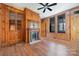 Spacious living room featuring hardwood floors, built-in shelving, and a wood-burning fireplace at 414 W Harvie Ave, Gastonia, NC 28052