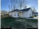 Front view of a small home with a yellow door and small yard at 4470 Kingsbury Rd, Midland, NC 28107