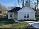 Small gray sided home with yellow door and small lawn at 4470 Kingsbury Rd, Midland, NC 28107