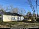 Rear view of a white vinyl sided home with a fenced backyard at 4470 Kingsbury Rd, Midland, NC 28107