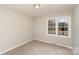 Bright bedroom with neutral walls and carpet at 4630 Dawnwood Dr, Charlotte, NC 28212