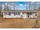 Brick ranch house with shutters, landscaping, and a walkway at 4630 Dawnwood Dr, Charlotte, NC 28212