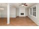 Living room with hardwood floors and a brick fireplace at 4630 Dawnwood Dr, Charlotte, NC 28212