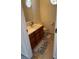 Clean bathroom with wood cabinets and updated flooring at 5138 Foley Dr, Hickory, NC 28601