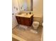 Clean bathroom with wood cabinets and updated flooring at 5138 Foley Dr, Hickory, NC 28601