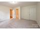 Bright bedroom featuring neutral carpeting and double closets at 5138 Foley Dr, Hickory, NC 28601