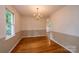 Formal dining room with hardwood floors, chandelier, and neutral wall colors at 5138 Foley Dr, Hickory, NC 28601