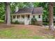 House with a porch and landscaping in a wooded area at 5138 Foley Dr, Hickory, NC 28601