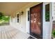 Home's front entrance with a brown door and screen door, and a welcoming mat at 5138 Foley Dr, Hickory, NC 28601