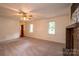 Open living area with hardwood and carpeted floors, fireplace, and large windows at 5138 Foley Dr, Hickory, NC 28601