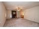 Spacious living room featuring a brick fireplace and neutral carpeting at 5138 Foley Dr, Hickory, NC 28601