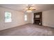 Living room with brick fireplace, ceiling fan, and carpet at 5138 Foley Dr, Hickory, NC 28601