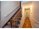 Interior view of a staircase with a wooden handrail and carpeted steps at 5138 Foley Dr, Hickory, NC 28601