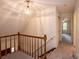 Upstairs hallway with wooden railing and carpet flooring at 5138 Foley Dr, Hickory, NC 28601